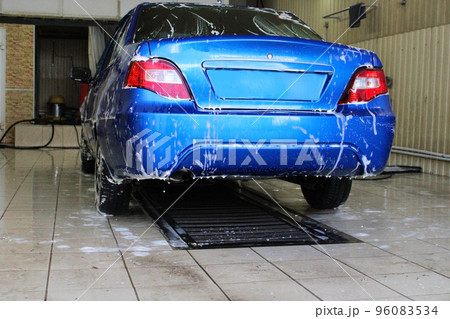 Blue car close-up at the car wash. Conception of ecology and environmental pollution. 96083534