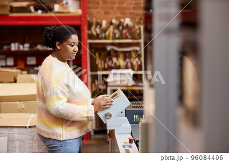 Black Woman Using Printing Machine 96084496