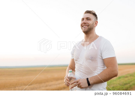 Wet sporty man resting after run 96084691