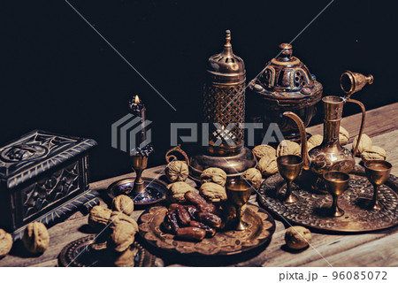 Persian Tea and teapots pouring hot tea in tea cups at a table. 96085072