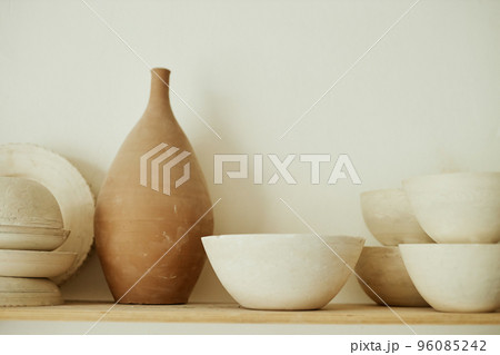 Raw handmade ceramics on shelf in pottery studio Raw handmade ceramics on shelf in pottery studio 96085242