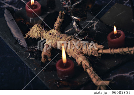 Voodoo doll in ritual scene close up, magic table with candles, witchcraft and spirituality concept. 96085355