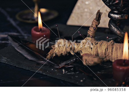 Voodoo doll in ritual scene close up, magic table with candles, witchcraft and spirituality concept. 96085358
