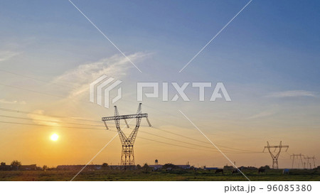 High voltage electric poles, rural landscape with power pylons in a row, at sunset High voltage electric poles, rural landscape with power pylons in a row, at sunset 96085380