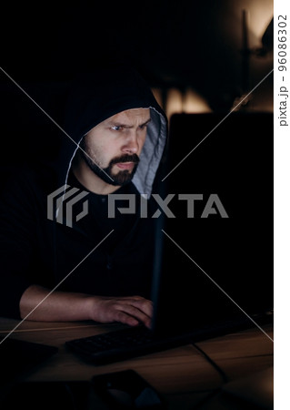 Man using pc for cyber crime 96086302
