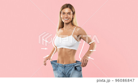 Slimming Result. Happy Slim Woman Wearing Oversized Jeans Posing On Pink Background Slimming Result. Happy Slim Woman Wearing Oversized Jeans Posing On Pink Background 96086847