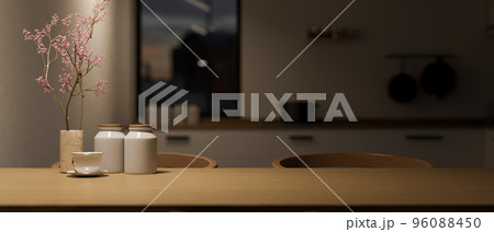 Modern wood dining table with copy space over blurred dark kitchen in background. Modern wood dining table with copy space over blurred dark kitchen in background. 96088450
