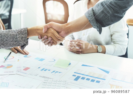 business merger, Asian businessmen shake hands at the conference room with showcase their collaboration to strengthen their marketing efforts. 96089587