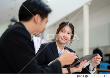 Asian portrait of people working together on a new project to analyze budgets and manage investment risks in today's profit boosting for marketing in the office room. 96089912