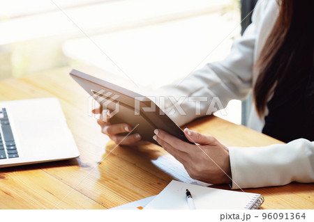 business woman using a tablet computer for data analysis, marketing, accounting. 96091364