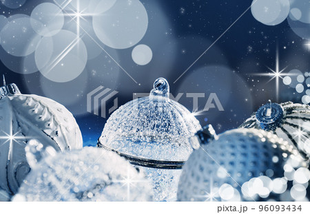 Beautiful Christmas white crystal baubles with sparks on festive universe blue glitter background. Merry Christmas or Happy new year card or banner concept. Bauble xmas planets Beautiful Christmas white crystal baubles with sparks on festive universe blue glitter background. Merry Christmas or Happy new year card or banner concept. Bauble xmas planets 96093434