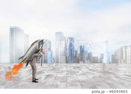 Determination and power businessman that holds a rocket Determination and power businessman that holds a rocket 96093665