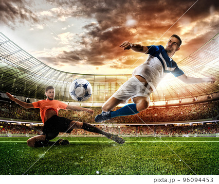 Football scene with competing football players at the stadium 96094453