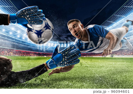 Goalkeeper catches the ball in the stadium 96094601