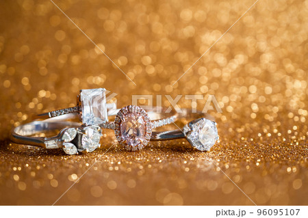 Jewelry diamond ring with abstract festive glitter Christmas holiday texture background blur with bokeh light 96095107