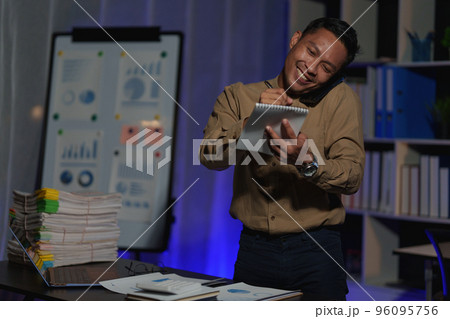 Stressed business man working over time at night. business account and finance concept Stressed business man working over time at night. business account and finance concept 96095756