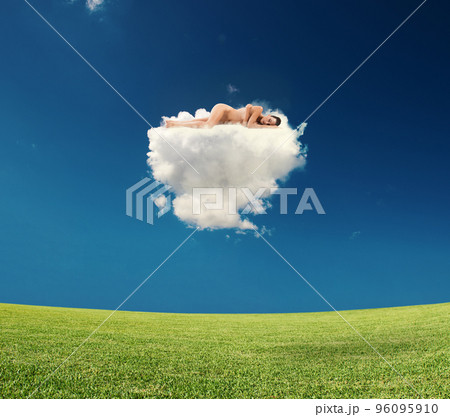 Young woman sleeps on a cloud 96095910