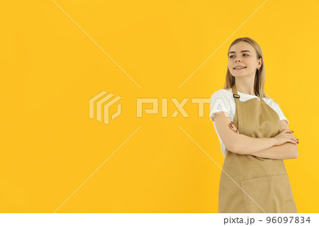 Concept of occupation, young female waiter on yellow background 96097834