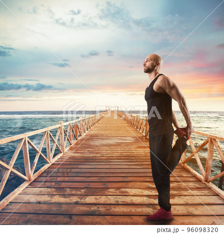 Exercises of gymnastics on a pier 96098320