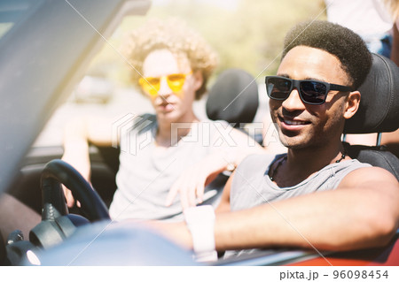 Young friends in cabriolet car ready to vacation 96098454