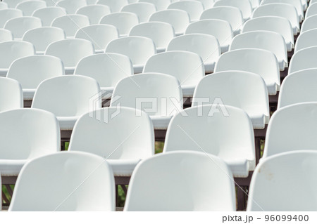 Seats of tribune on sport stadium. Concept of fans, chairs for audience, cultural environment concept. mpty seats, modern stadium. Seats of tribune on sport stadium. Concept of fans, chairs for audience, cultural environment concept. mpty seats, modern stadium. 96099400