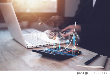 Individual income tax paid with Thailand baht (Bank money) and corporations concept. Businessman using a calculator and laptop (notebook) of Data analysis, Paperwork, financial research, and report. 96099645