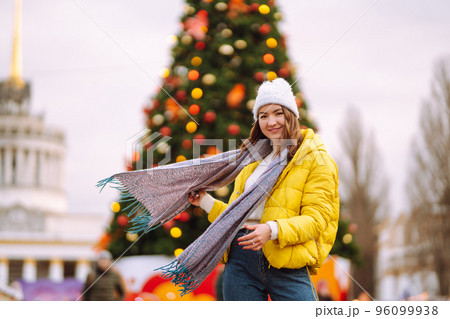 Happy woman ice skating on the ice arena in the city square on Festive Christmas fair. Cold weather. Happy woman ice skating on the ice arena in the city square on Festive Christmas fair. Cold weather. 96099938