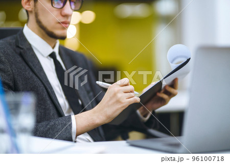 A man signs a contrac, legal or business agreements. Male hand with pen makes notes. A man signs a contrac, legal or business agreements. Male hand with pen makes notes. 96100718
