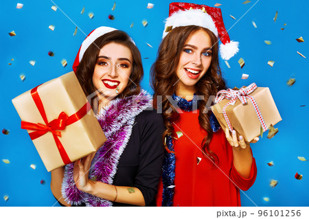 nice portrait of two happy young women in santa claus hat with gift .Christmas concept. 96101256