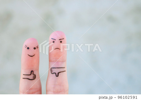 Fingers art of couple. Woman showing thumbs up and man showing thumbs down. Concept of disagreement in family. 96102591