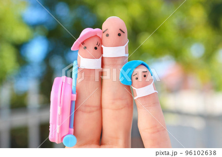 Fingers art of happy family with face mask. Man and woman going on vacation. Fingers art of happy family with face mask. Man and woman going on vacation. 96102638