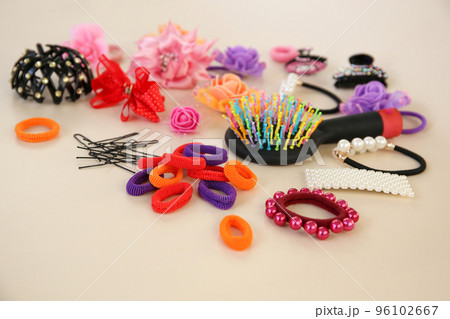Different hair clips on beige background. 96102667