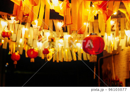 Chinese paper red lanterns hang with garlands of ribbons and lamps at night in the yard. The Lantern Festival also called Shangyuan Festival, Chinese New Year, end of spring festival Chinese paper red lanterns hang with garlands of ribbons and lamps at night in the yard. The Lantern Festival also called Shangyuan Festival, Chinese New Year, end of spring festival 96103077