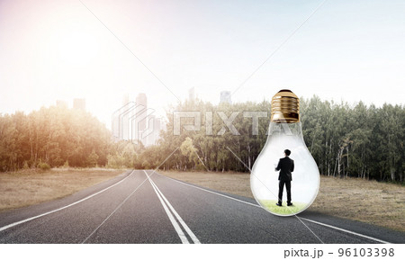 Businessman inside light bulb 96103398