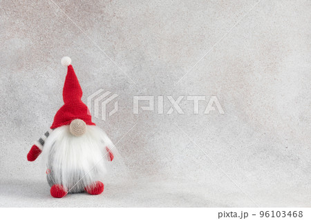 Christmas handmade gnome in red hat holiday banner on light winter background Christmas handmade gnome in red hat holiday banner on light winter background 96103468