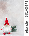 Xmas gnome in red hat with fir branch holiday card on light winter background 96103475