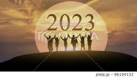 Happy new year 2023, Keep fighting together, Silhouette of 2023 letters on the mountain with business people raised arms in teamwork concept at sunrise.. Happy new year 2023, Keep fighting together, Silhouette of 2023 letters on the mountain with business people raised arms in teamwork concept at sunrise.. 96104152