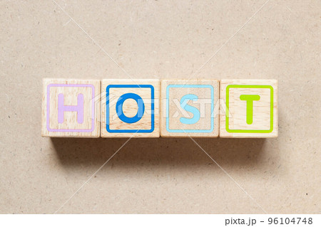 Color letter block in word host on wood background 96104748