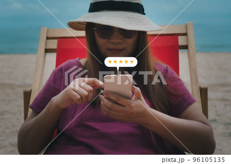 Young woman hand using smartphone with popup five star icon for feedback review satisfaction service, Customer service experience and business satisfaction survey concept.. Young woman hand using smartphone with popup five star icon for feedback review satisfaction service, Customer service experience and business satisfaction survey concept.. 96105135