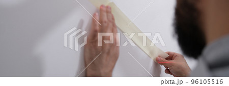 Sticker tape on wall before painting closeup Sticker tape on wall before painting closeup 96105516