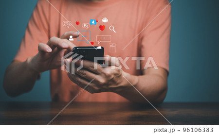 Man using smartphone with social media icons, love, search, people, group, shopping, document. Mobile Phone application and social media marketing concept. Man using smartphone with social media icons, love, search, people, group, shopping, document. Mobile Phone application and social media marketing concept. 96106383
