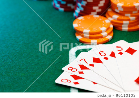 Playing cards and chips on green casino table background 96110105