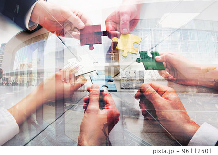 Teamwork of partners. Concept of integration and startup with puzzle pieces. double exposure 96112601