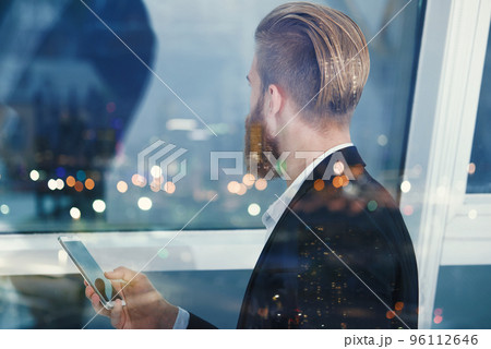 Businessman looks far for the future into the night. Concept of innovation and startup Businessman looks far for the future into the night. Concept of innovation and startup 96112646