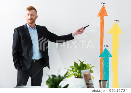 Businessman draws positive statistics of his company. Concept of success 96112724