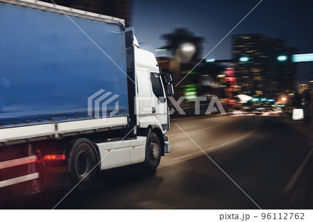 Fast truck on a city road delivering at night Fast truck on a city road delivering at night 96112762