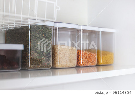 Storage ideas in the kitchen. White box and basket. Shelf order system.  96114354