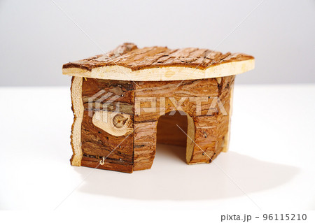 a small wooden house for a hamster and a mouse on a white background. a small wooden house for a hamster and a mouse on a white background. 96115210
