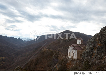 monastery on cliff, holy place in mountains, autumn landscape, old Orthodox church 96115583