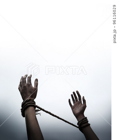 Tied hands raised to the sky Tied hands raised to the sky 96116029